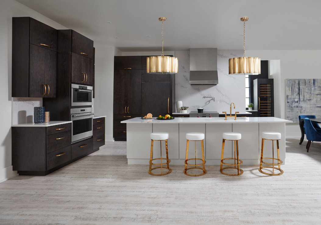 Kiba Studios kitchen design featuring white ceramic tiled floors, white quartz island and barstools, dark wood cabinets